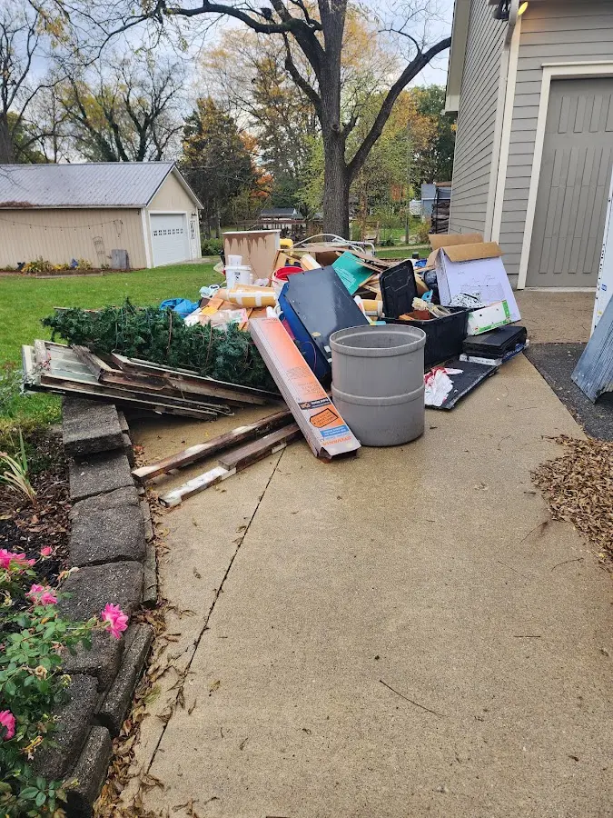 Dumpster being loaded with debris for Estate Cleanout Dumpster Rental in White Deer